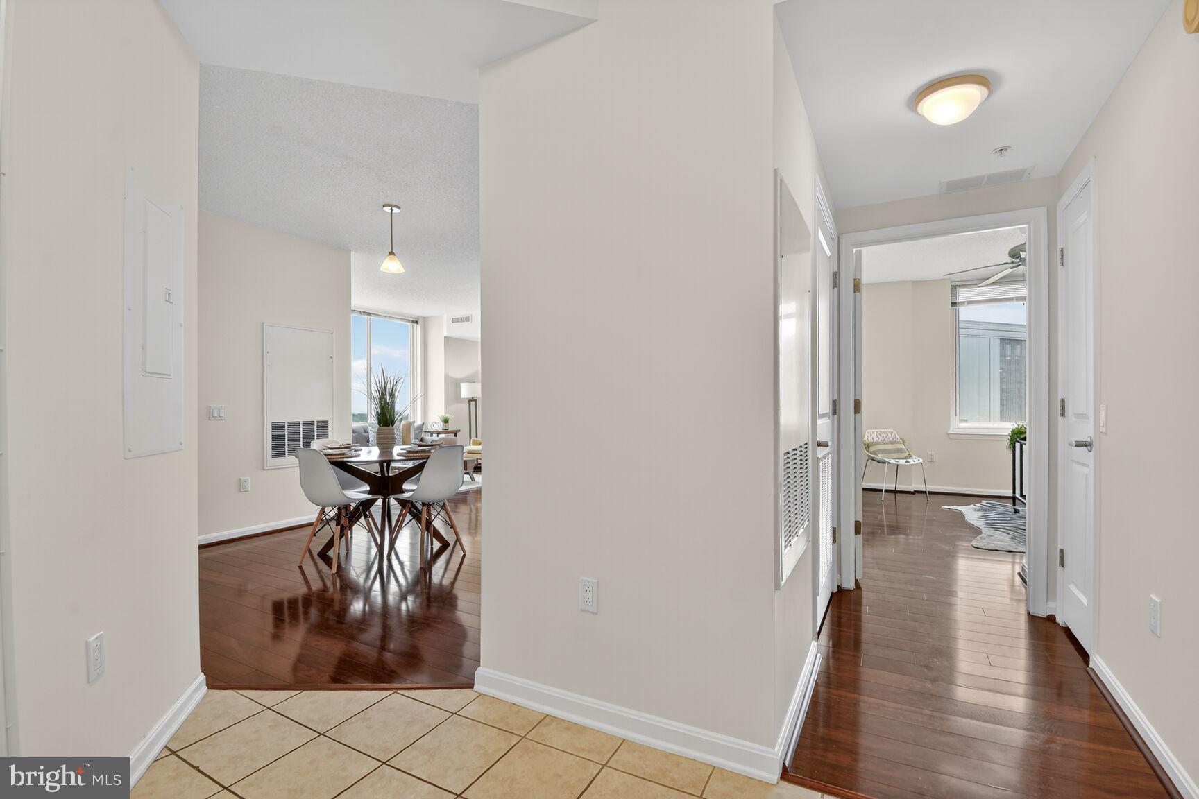 930 Wayne Avenue, Unit 1210 Silver Spring, MD 20910 - Photo 22 of 42 a view of a hallway and a livingroom with furniture