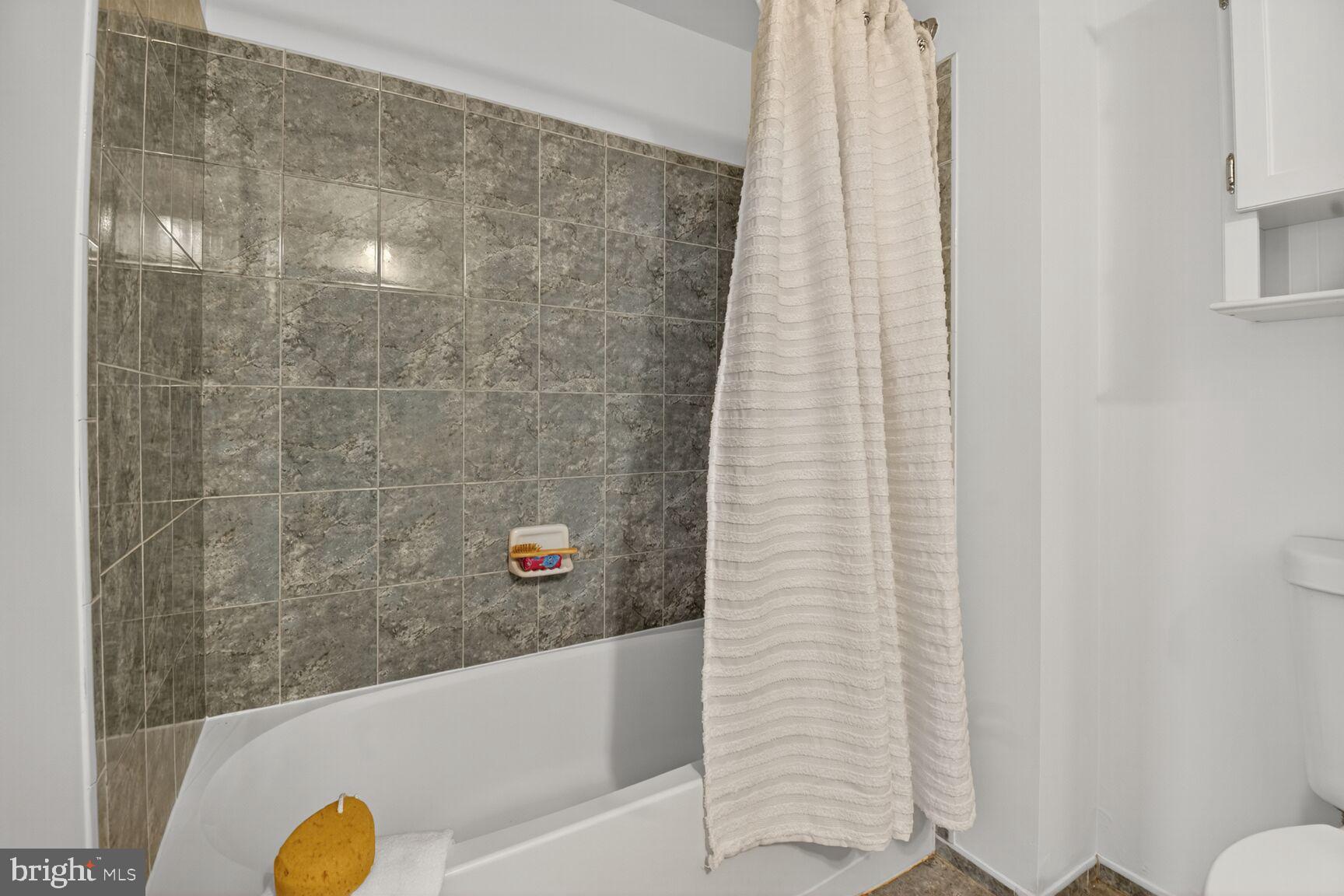 930 Wayne Avenue, Unit 1210 Silver Spring, MD 20910 - Photo 26 of 42 a bathroom with a shower