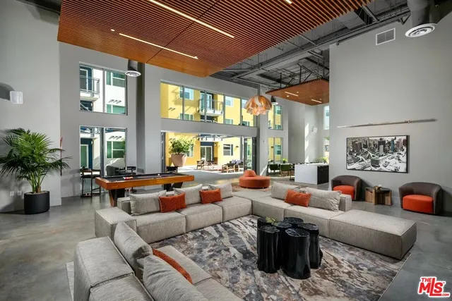 a living room with furniture fireplace and large windows