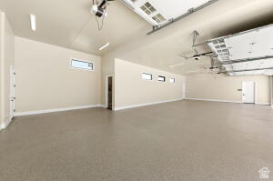 1141 East Lost Ridge Drive Washington, UT 84780 - Photo 26 of 108 Spacious garage with high ceilings, light beige walls, and light gray concrete flooring