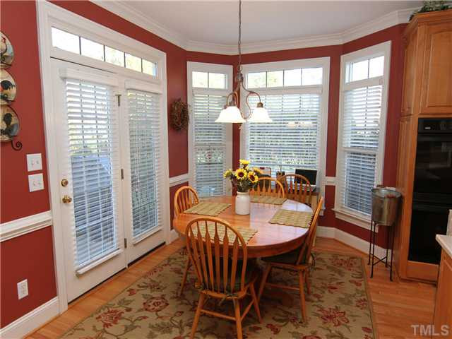 12501 Ribbongrass Court Raleigh, NC 27614 - Photo 9 of 25 Breakfast room with lovely window to side yard and french doors to deck. Opens to kitchen and family room. Note the window transoms and chair rail. Breakfast Area