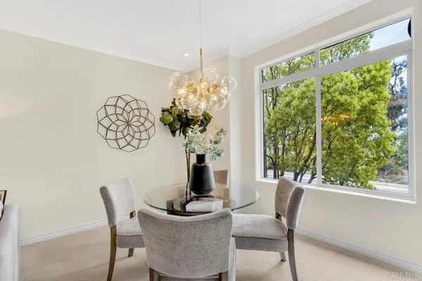 a view of a dining room with furniture window and outside view