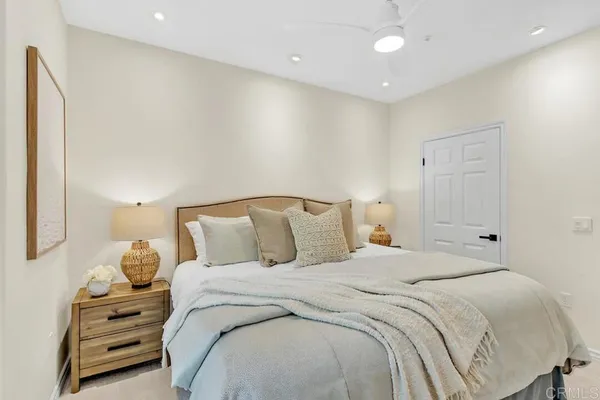 a bedroom with a bed and a night stand