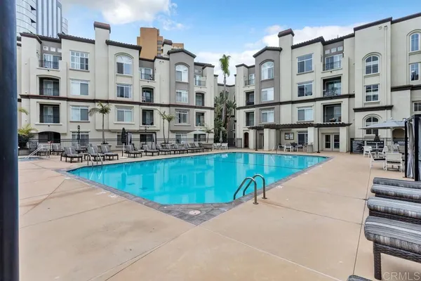 a view of a swimming pool with outdoor seating