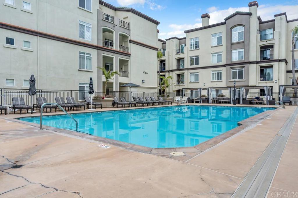 9253 Regents Road, Unit A203 San Diego, CA 92037 - Photo 38 of 38 a view of a swimming pool with a lounge chairs