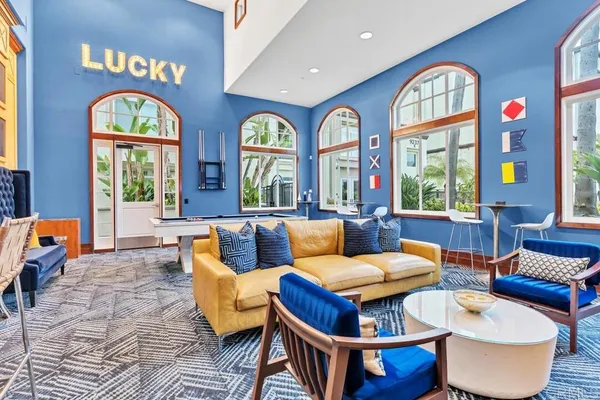 a living room with furniture a chandelier and a large window