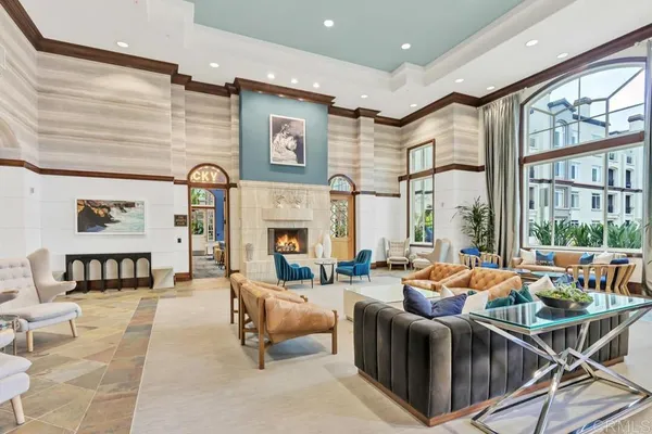 a living room with furniture large window and a fireplace