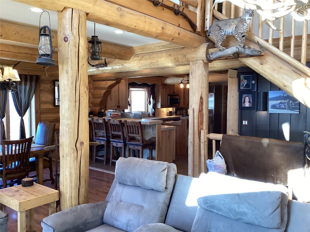 9073 54 7/10 Road Molina, CO 81646 - Photo 11 of 38 Living area featuring log walls, wood finished floors, recessed lighting, and beam ceiling