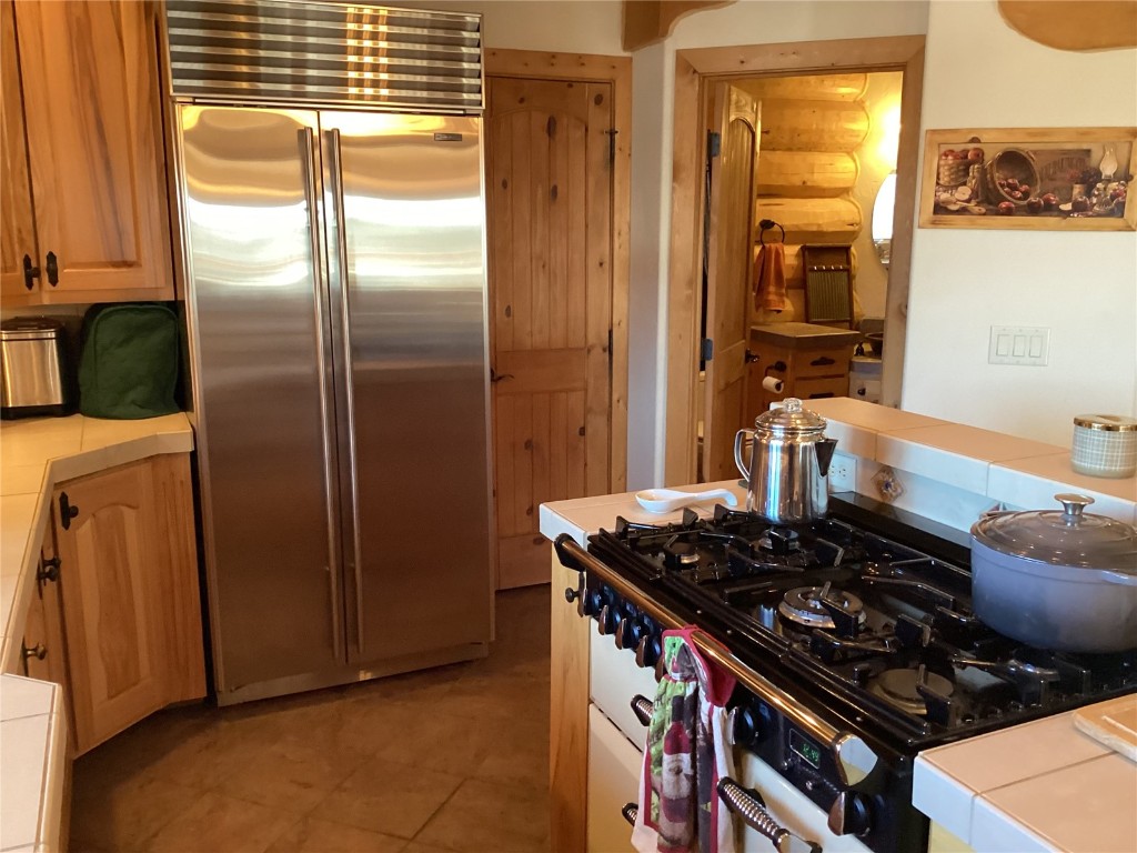 9073 54 7/10 Road Molina, CO 81646 - Photo 17 of 38 Kitchen featuring tile countertops, gas stove, and stainless steel built in refrigerator