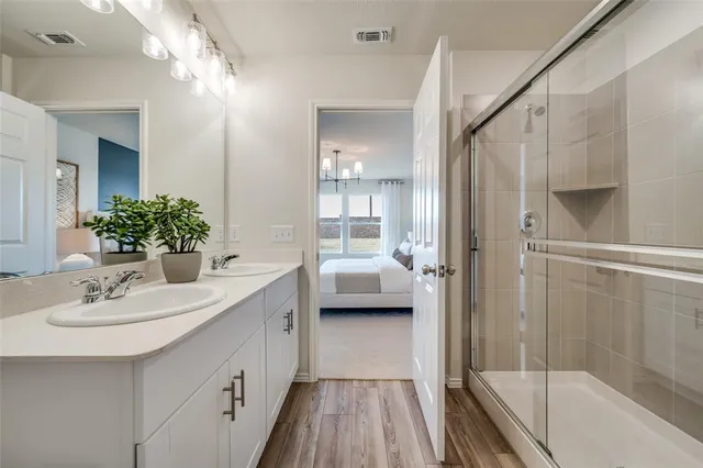 a kitchen with stainless steel appliances granite countertop wooden floors a stove and a sink