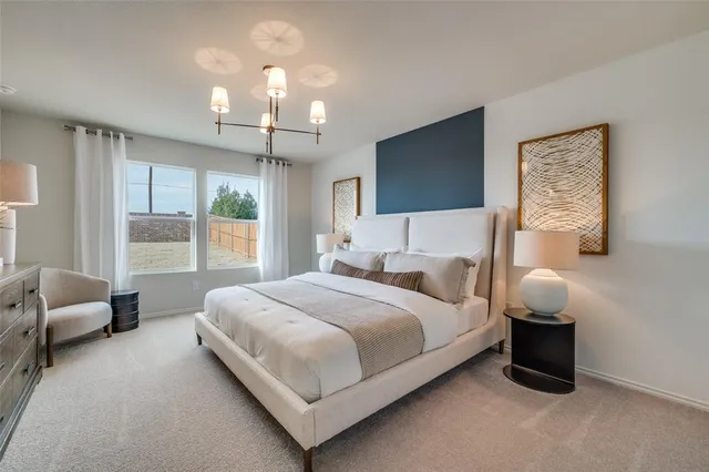 a en suite bathroom with a double vanity sink a mirror and shower