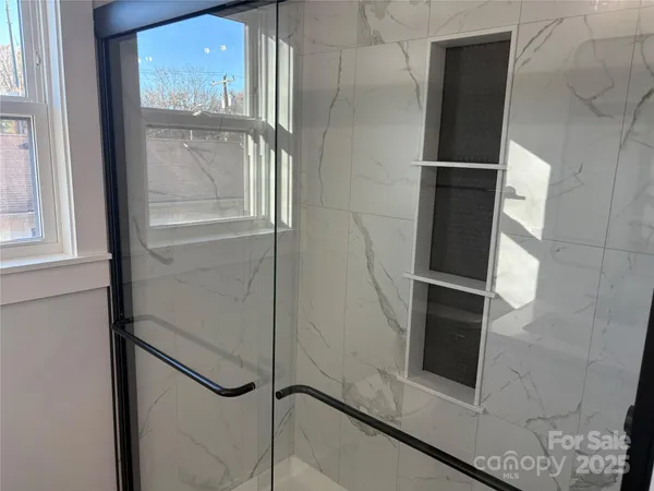 a bathroom with a glass shower door