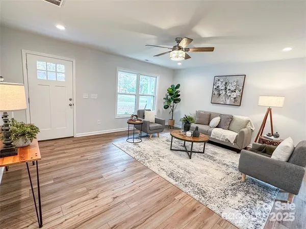 a living room with furniture and wooden floor