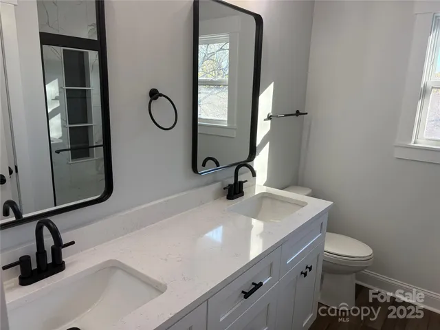 a bathroom with a toilet sink and mirror