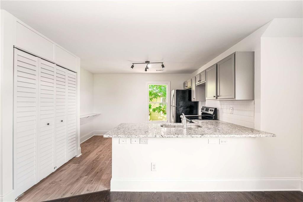 94 Lucy Street Southeast, Unit A Atlanta, GA 30312 - Photo 11 of 25 a view of kitchen with granite countertop cabinets and window