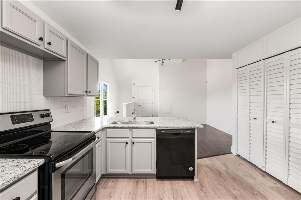 94 Lucy Street Southeast, Unit A Atlanta, GA 30312 - Photo 15 of 25 a kitchen with a sink a stove and cabinets