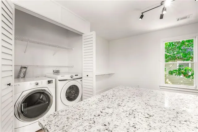 a view of a bedroom with washer and dryer