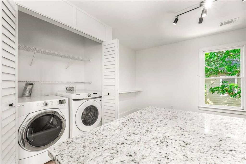 94 Lucy Street Southeast, Unit A Atlanta, GA 30312 - Photo 16 of 25 a view of a bedroom with washer and dryer