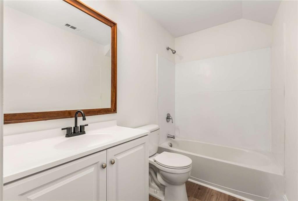 94 Lucy Street Southeast, Unit A Atlanta, GA 30312 - Photo 18 of 25 a bathroom with a sink a toilet and shower