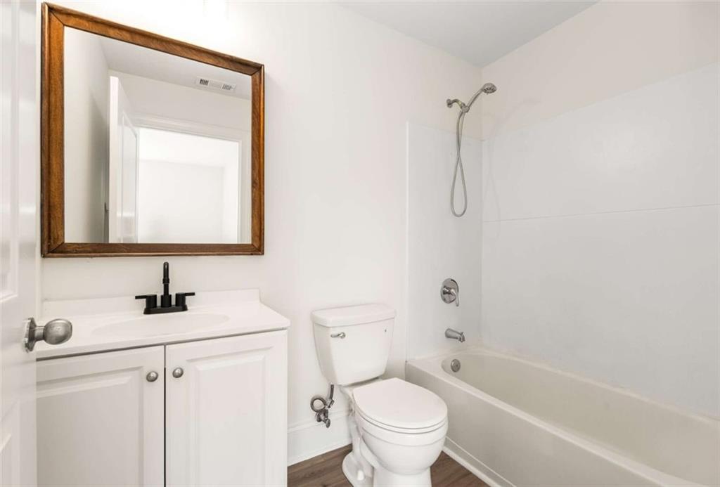 94 Lucy Street Southeast, Unit A Atlanta, GA 30312 - Photo 23 of 25 a bathroom with a sink toilet and shower