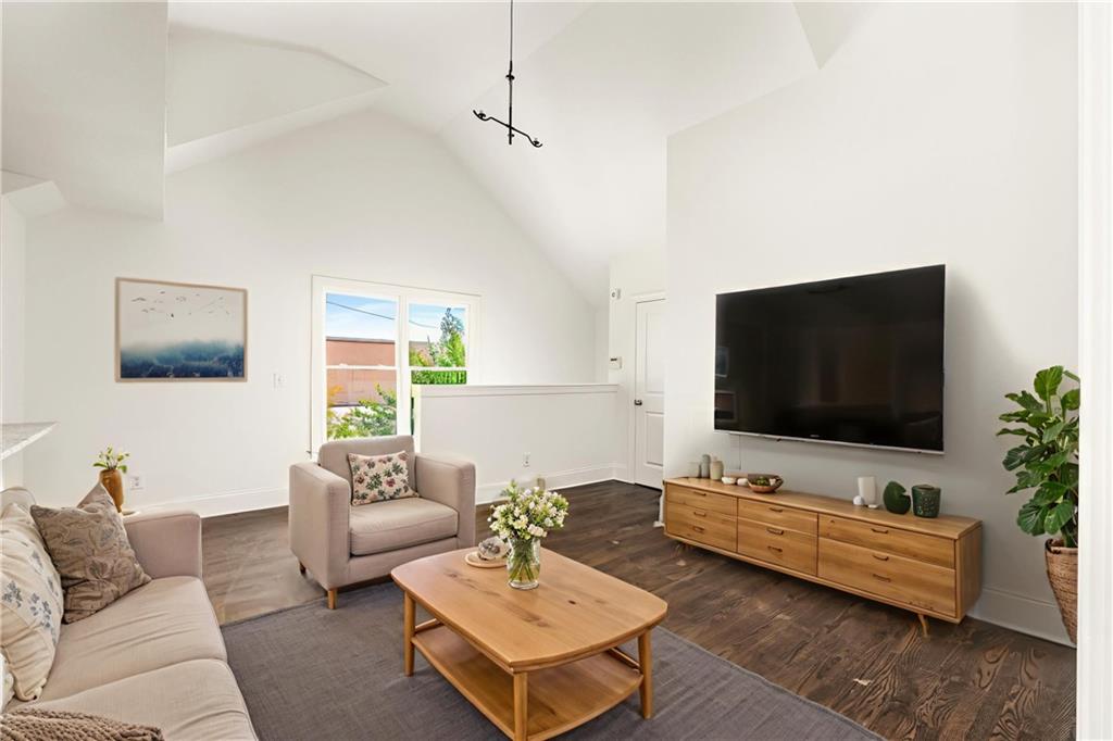 94 Lucy Street Southeast, Unit A Atlanta, GA 30312 - Photo 3 of 25 a living room with furniture and a flat screen tv