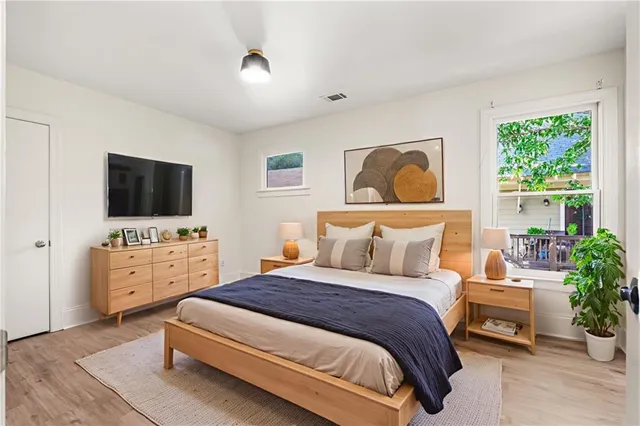 a bedroom with a bed and a flat screen tv