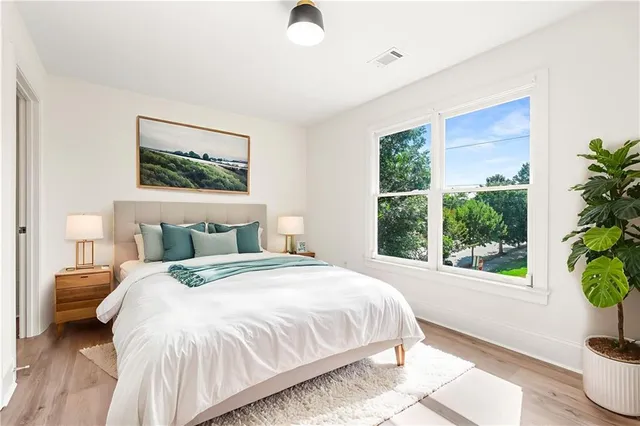 a bedroom with a bed and a potted plant