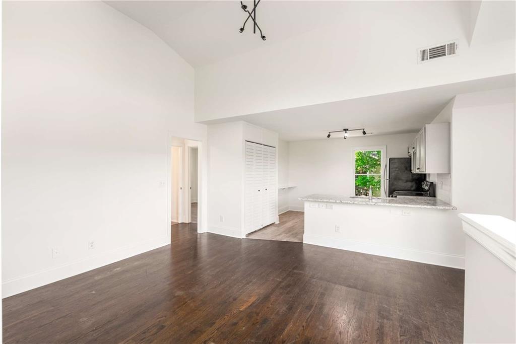 94 Lucy Street Southeast, Unit A Atlanta, GA 30312 - Photo 9 of 25 a view of a big room with wooden floor and a window