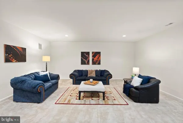 a living room with furniture and a lamp