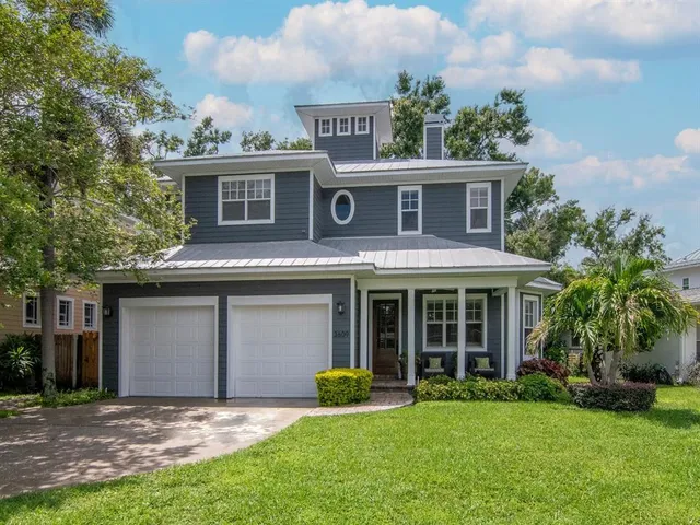 a front view of a house with a garden and yard