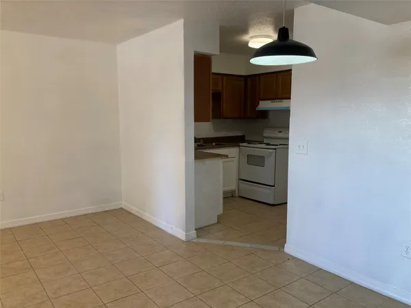 a kitchen with a stove and a refrigerator