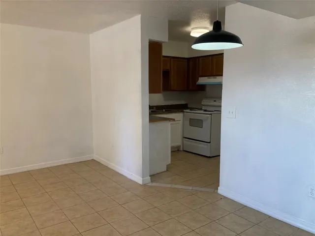 a kitchen with a stove and a refrigerator