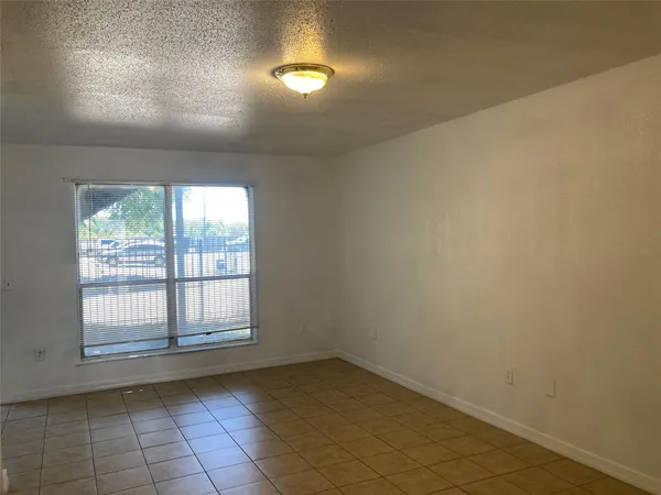 an empty room with a empty space and windows