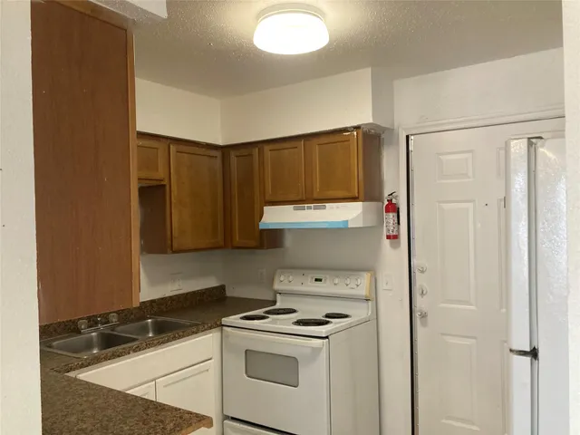a kitchen with a stove and a refrigerator