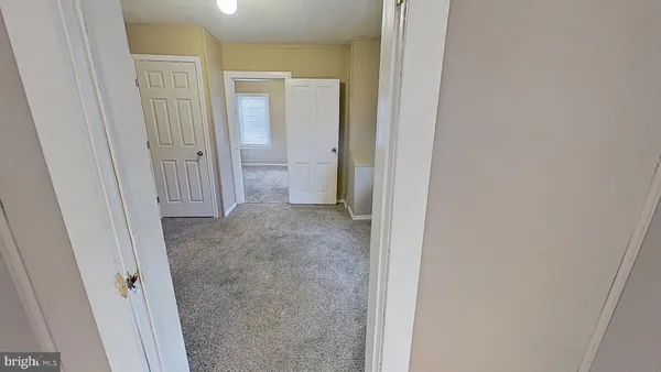 a view of a bathroom from a hallway