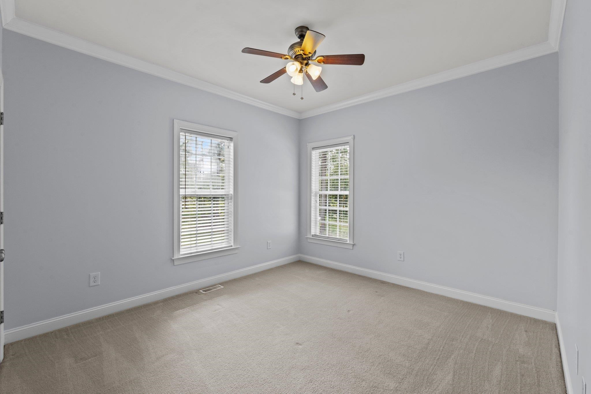 525 Eatmon Road Zebulon, NC 27597 - Photo 16 of 30 Bedroom 4 with carpet, ceiling fan, and 2 windows. Bedroom 4