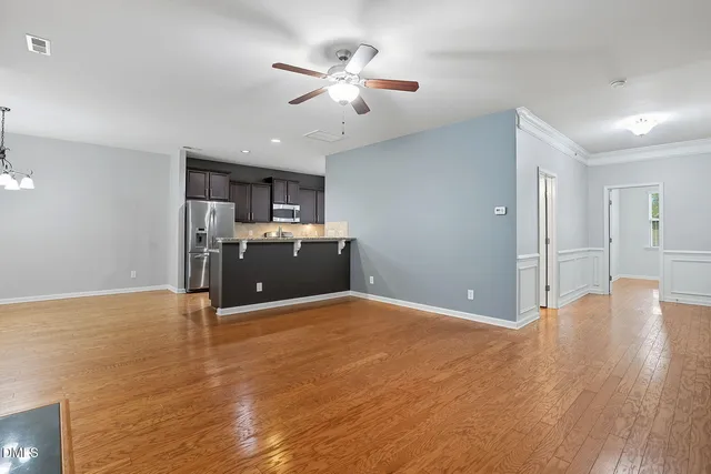 a view of an empty room with a fireplace and a window