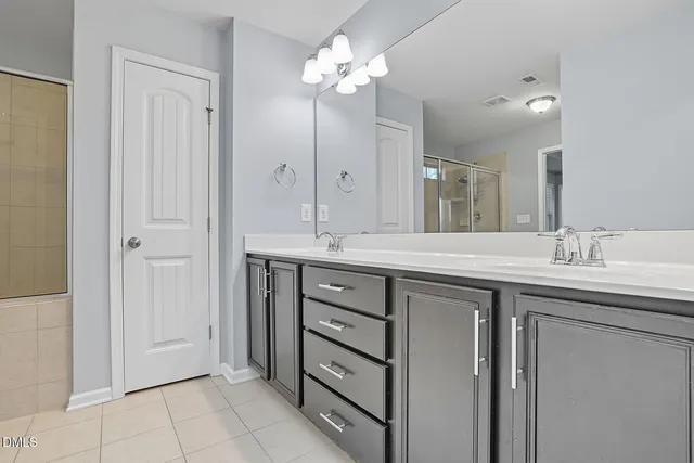 a bathroom with a glass shower door