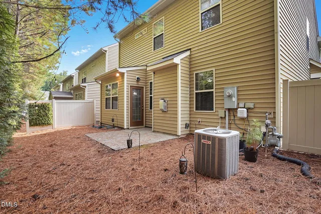 a view of a yard with plants and trees