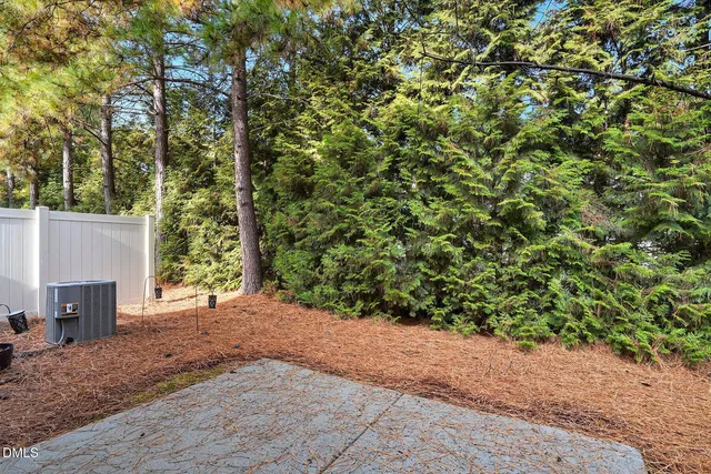 a front view of a house with a parking space