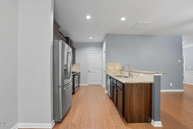 a kitchen with a sink and a refrigerator