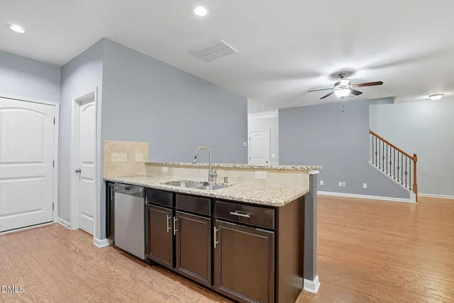 a bathroom with a granite countertop sink a light fixture and a mirror