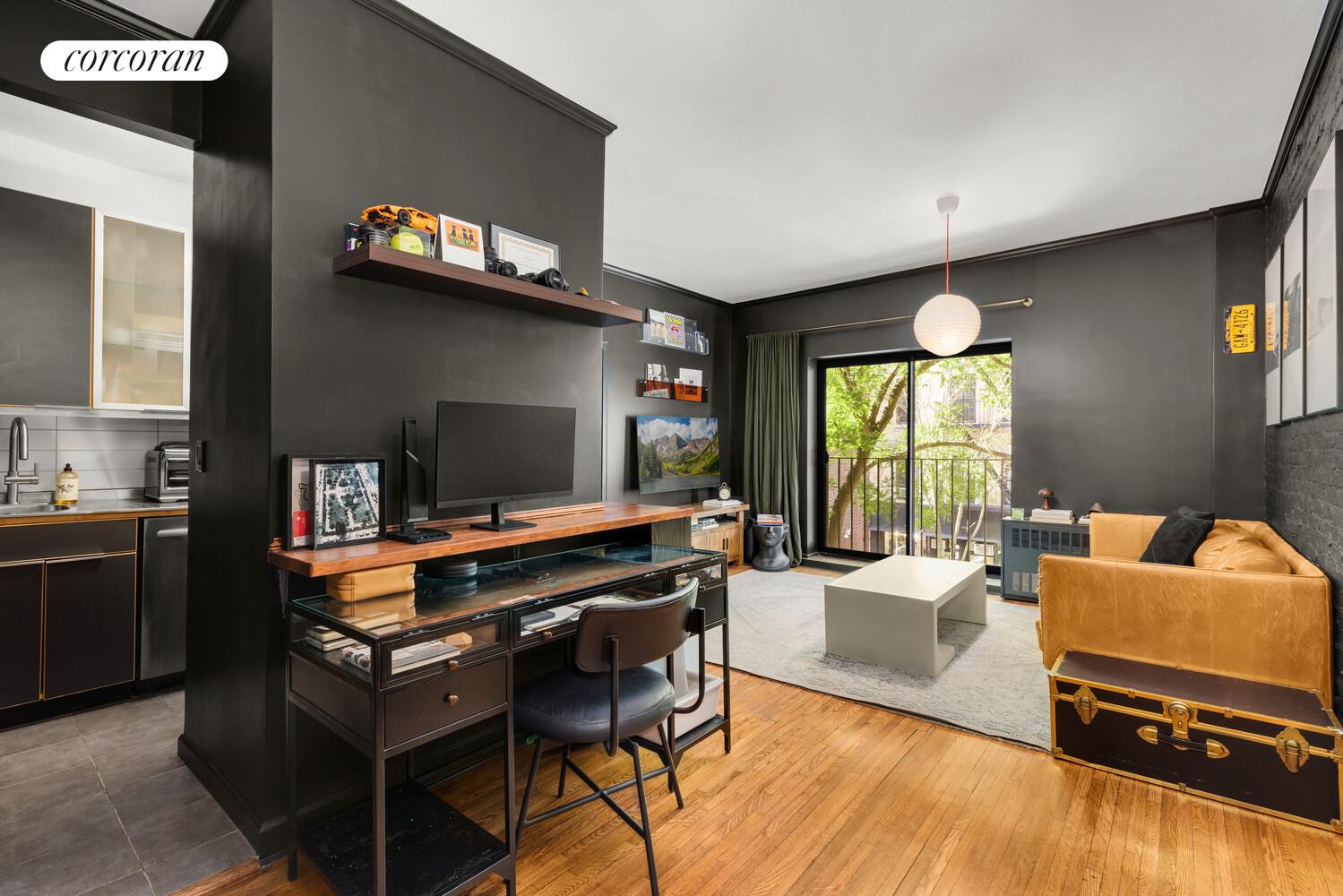 207 East 21st Street, Unit 3B Manhattan, NY 10010 - Photo 2 of 6 a living room with furniture and a flat screen tv