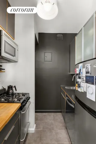 a kitchen with stainless steel appliances a sink stove and cabinets