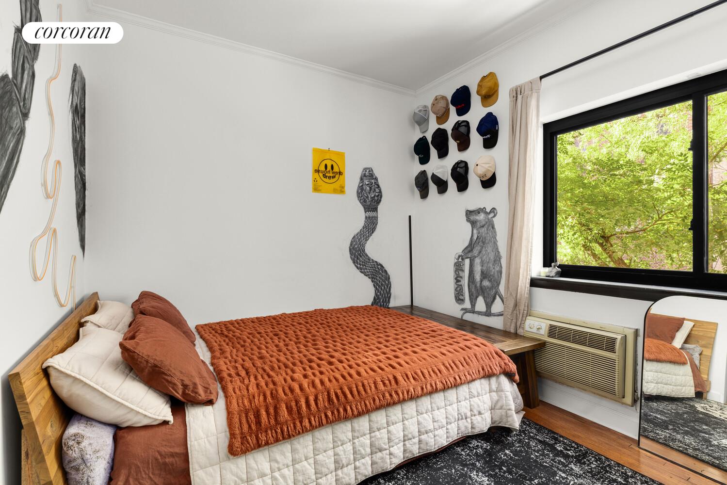 207 East 21st Street, Unit 3B Manhattan, NY 10010 - Photo 4 of 6 a bedroom with a bed and wooden floor