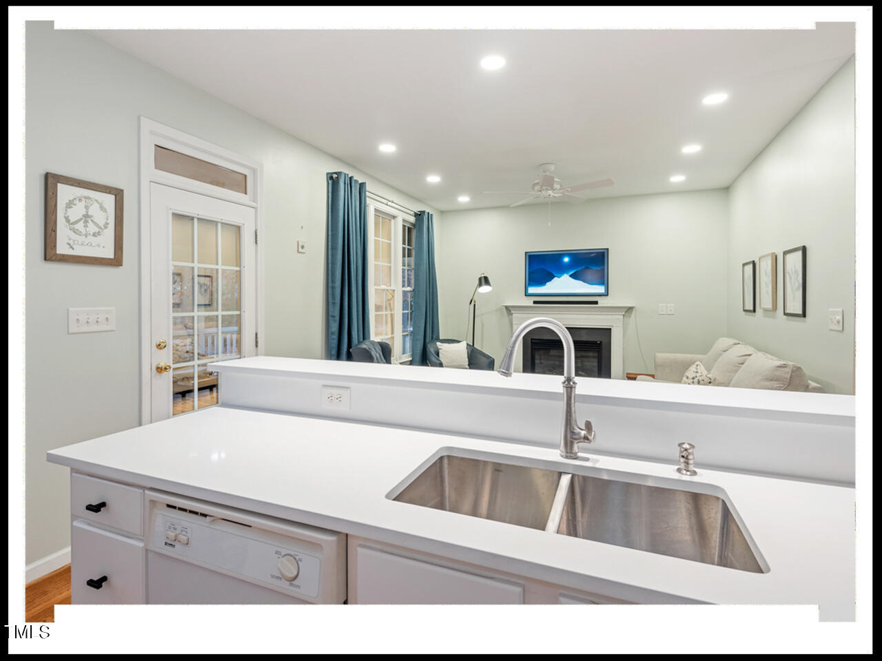 8214 Morrell Lane Durham, NC 27713 - Photo 15 of 48 a kitchen with a sink and a refrigerator