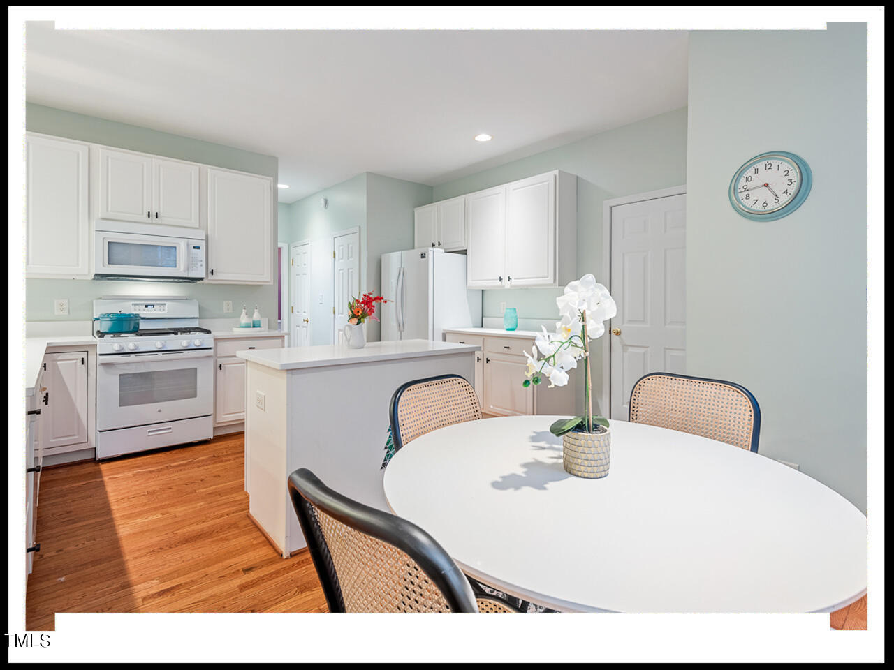 8214 Morrell Lane Durham, NC 27713 - Photo 18 of 48 a kitchen with stainless steel appliances granite countertop a table chairs and a refrigerator