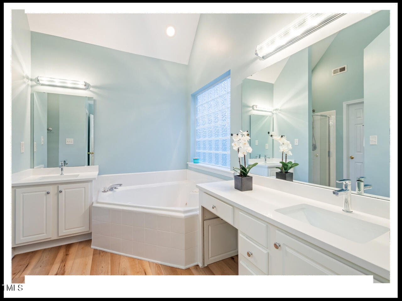 8214 Morrell Lane Durham, NC 27713 - Photo 29 of 48 a bathroom with a sink a large mirror and a bathtub