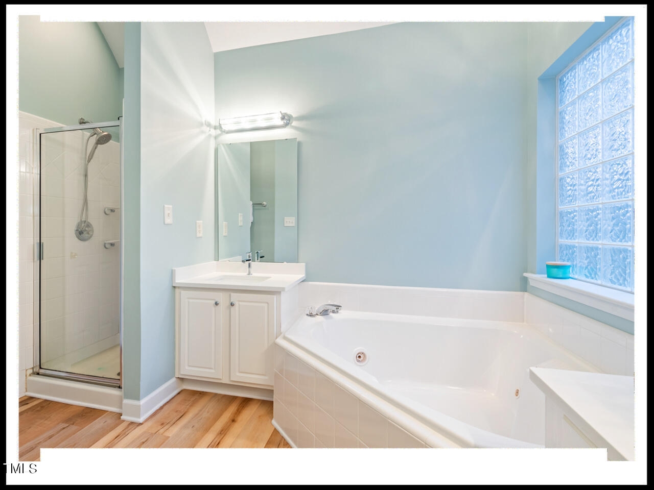 8214 Morrell Lane Durham, NC 27713 - Photo 30 of 48 a bathroom with a tub a sink and a mirror