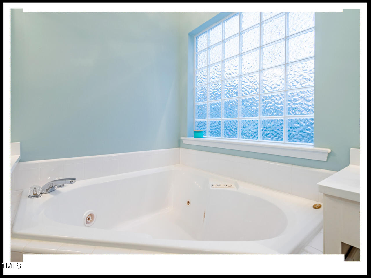 8214 Morrell Lane Durham, NC 27713 - Photo 31 of 48 a bathroom with a bathtub and a window